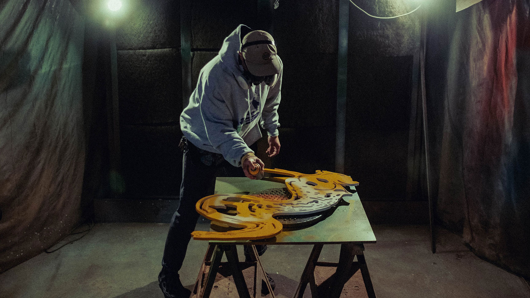 Giroux spraying a sculptural cut out with Montana spray paint.